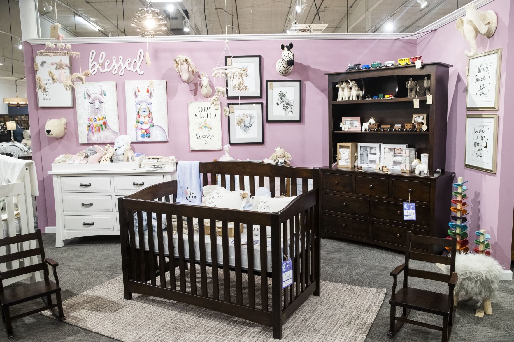 Baby and toddler decor and furniture is displayed on the showroom floor.